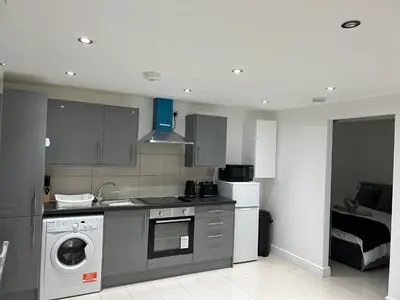 a kitchen with a washing machine and a washer at Lovely holiday home in Southminster in Southminster