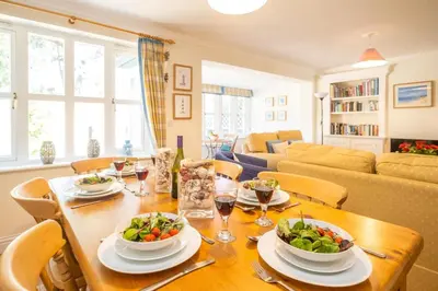 a dining room with a table with two bowls of food at 12 Prevetts Way - Aldeburgh Coastal Cottages in Aldeburgh
