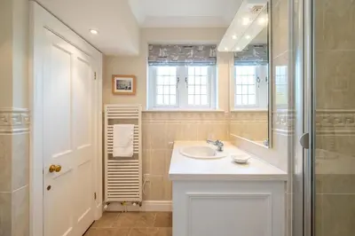 a bathroom with a sink and a shower at 12 Prevetts Way - Aldeburgh Coastal Cottages in Aldeburgh