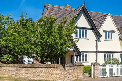 a white house with a brick wall at 12 Prevetts Way - Aldeburgh Coastal Cottages in Aldeburgh