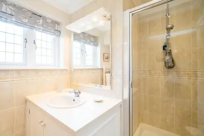 a bathroom with a sink and a shower at 12 Prevetts Way - Aldeburgh Coastal Cottages in Aldeburgh