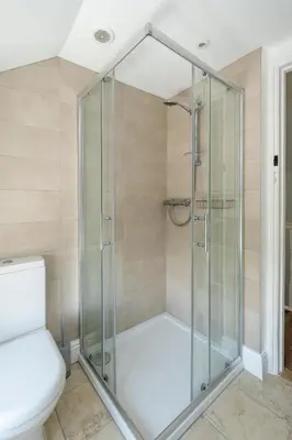 a glass shower in a bathroom with a toilet at Laurel Cottage - Aldeburgh Coastal Cottages in Blyford