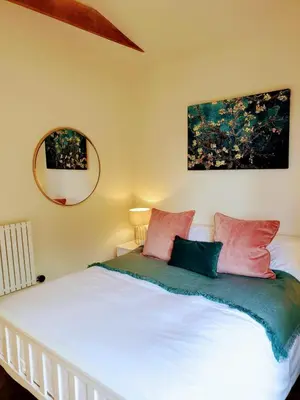 a bedroom with a white bed with pink and blue pillows at Finest Retreats - Blackbarn Wood in Balsham
