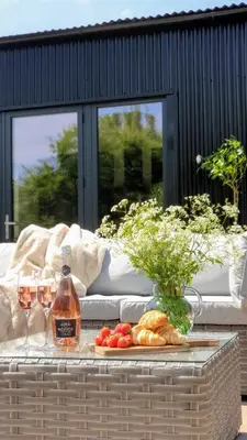 a table with two glasses of wine and a tray of food at Finest Retreats - Blackbarn Wood in Balsham