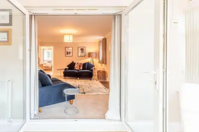 a view of a living room from a sliding glass door at Potters Brook in Framlingham