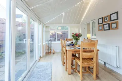 a dining room with a table and chairs at Potters Brook in Framlingham