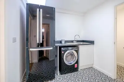 a kitchen with a washing machine in a room at Skippers Cottage - Aldeburgh Coastal Cottages in Aldeburgh