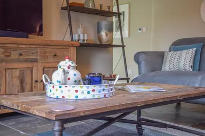 a coffee table with a tea pot on top of it at Halcyon Barn, Wissett in Wissett