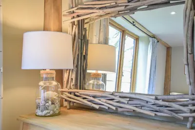 two lamps on a table in front of a mirror at Halcyon Barn, Wissett in Wissett