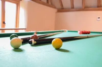 a billiard table with balls on top of it at Halcyon Barn, Wissett in Wissett