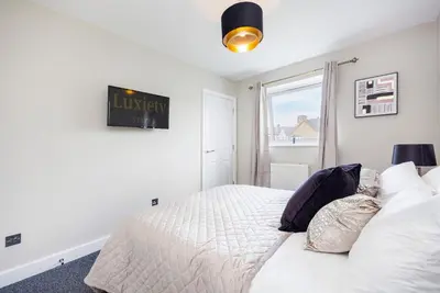 a bedroom with a white bed and a window at Modern 1BR By Luxiety Stays Short Lets & Serviced Accommodation Southend on sea - City Centre, Nr the beach, High St & Adventure Island in Southend-on-Sea