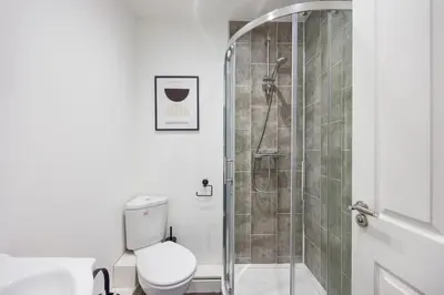 a bathroom with a shower and a toilet at Modern 1BR By Luxiety Stays Short Lets & Serviced Accommodation Southend on sea - City Centre, Nr the beach, High St & Adventure Island in Southend-on-Sea