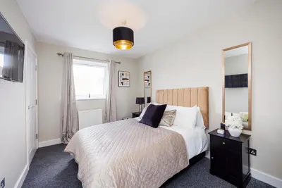 a bedroom with a bed and a large mirror at Modern 1BR By Luxiety Stays Short Lets & Serviced Accommodation Southend on sea - City Centre, Nr the beach, High St & Adventure Island in Southend-on-Sea