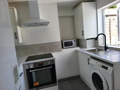 a kitchen with a sink and a washing machine at Vetrelax Colchester Three bedroom house- Sleeps up to 7 - Free Wi-Fi - Contractors - Families - Long Term Stays in Colchester