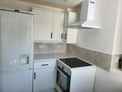 a kitchen with white cabinets and a stove top oven at Vetrelax Colchester Three bedroom house- Sleeps up to 7 - Free Wi-Fi - Contractors - Families - Long Term Stays in Colchester