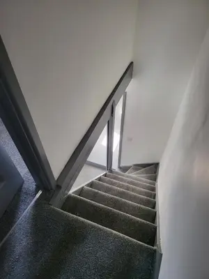 a staircase in a building with a stair case at Vetrelax Colchester Three bedroom house- Sleeps up to 7 - Free Wi-Fi - Contractors - Families - Long Term Stays in Colchester