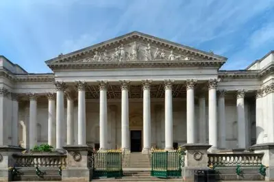 a large white building with white columns at Charming 1 bed super central Terraced House in Cambridge
