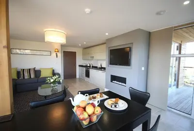 a living room with a dining table and a living room at Apple Tree Lodges in Colchester