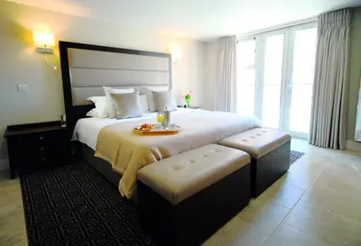 a hotel room with a large bed with a large window at Apple Tree Lodges in Colchester