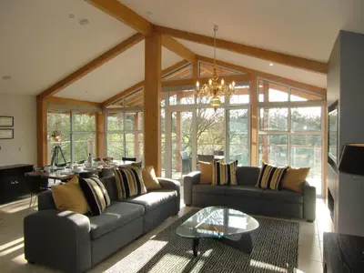 a living room with two couches and a table at Apple Tree Lodges in Colchester