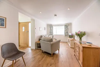 a living room with a couch and a chair at Hattie's, Great Glemham in Saxmundham
