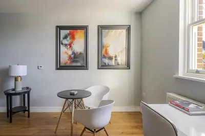 a living room with three pictures on the wall at Luxurious Private One Bedroom Apartment with Sky TV, Movies & Netflix in Braintree