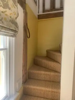 a staircase in a room with a window at Blythe Cottage in Long Melford