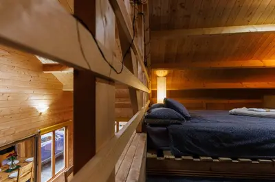 a bedroom in a log cabin with a bed at Spacious Cabin EVCharger and free Parking near Cambridge in Cambridge