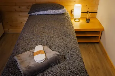 a bedroom with a large bed with a desk at Spacious Cabin EVCharger and free Parking near Cambridge in Cambridge