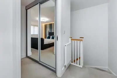 a hallway with a glass door leading to a bedroom at My Chester Luxury Home in Colchester
