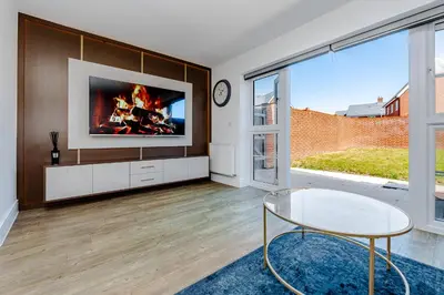 a living room with a tv on a wall at My Chester Luxury Home in Colchester