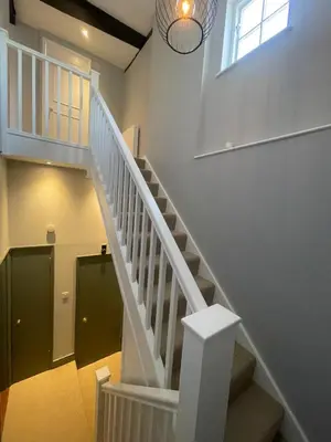 a white staircase in a house with a window at Cathedral View Apartment, Flat 4 in Bury Saint Edmunds