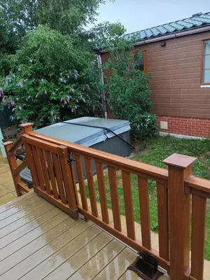 a wooden deck with a hot tub in the yard at Fern Lodge with Hot Tub in Stonham Aspall