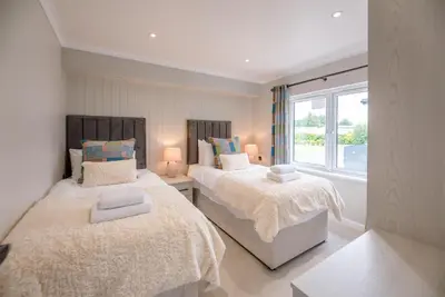 a bedroom with two beds and a window at Briargate, Aldeburgh in Aldeburgh