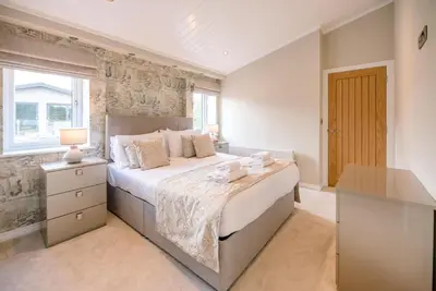 a bedroom with a large bed and a window at Marshwiggle, Aldeburgh in Aldeburgh