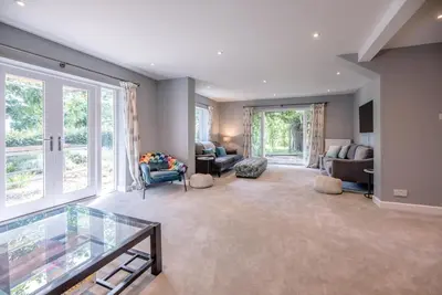 a large living room with a large window at Ferry Corner Cottage, Sudbourne in Woodbridge