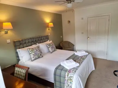a hotel room with a bed and a couch at The Courthouse Inn in Colchester