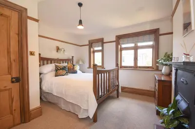 a bedroom with a bed and a window at Unique period one bedroom house in Colchester in Colchester