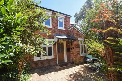 a brick house with a front door and trees at Unique period one bedroom house in Colchester in Colchester