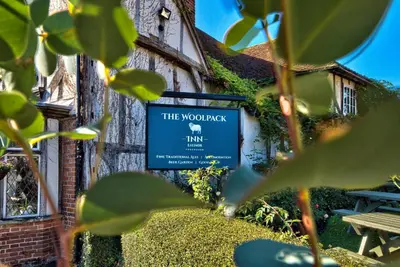 a sign for the woolpack inn in front of a building at The Woolpack Inn in Coggeshall
