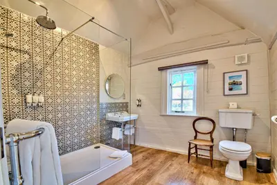 a bathroom with a tub and a toilet and a sink at The Woolpack Inn in Coggeshall