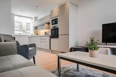 a living room with a couch and a table at Citystay Living - Dutch's Corner in Cambridge