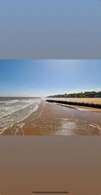 a view of a beach with a pier and the ocean at Penthouse Apartment with seaviews in Walton-on-the-Naze