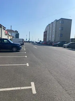 an empty parking lot with cars parked in it at Penthouse Apartment with seaviews in Walton-on-the-Naze