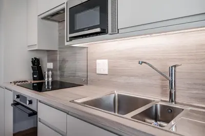 a kitchen with a sink and a microwave at Citystay Living - Holland Place in Cambridge