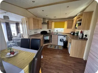 a kitchen and living room with a table and a dining room at None available in Jaywick Sands