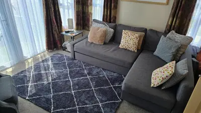 a living room with a gray couch with pillows at None available in Jaywick Sands