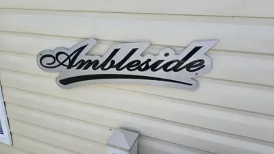 a sign on the side of a house at None available in Jaywick Sands