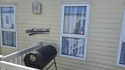 a chair on a porch next to a house at None available in Jaywick Sands