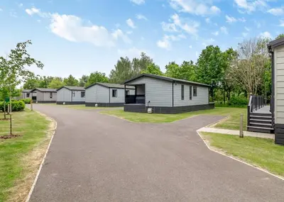 a row of modular homes on a driveway at The Essex Golf And Country Club in Markshall